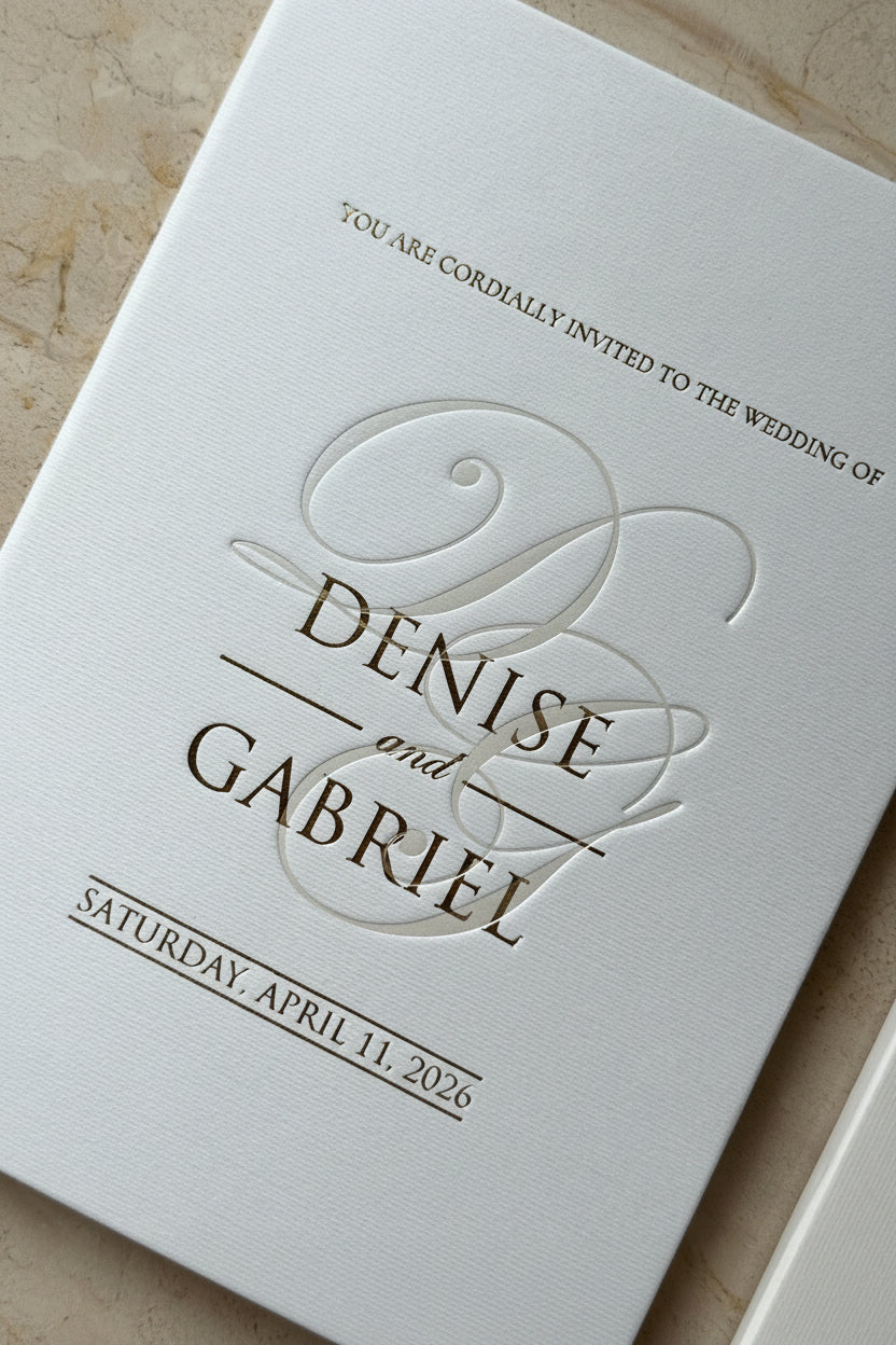 Hardcover Wedding invitation with 'Denise and Gabriel' on a textured ivory paper, gold foiling and pearl press
