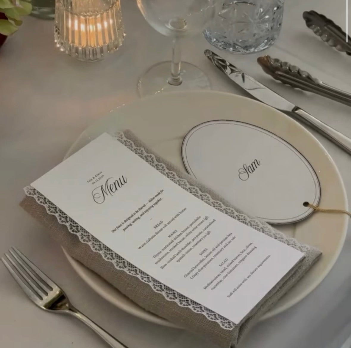 Table setting with a menu card and name tag on a plate.