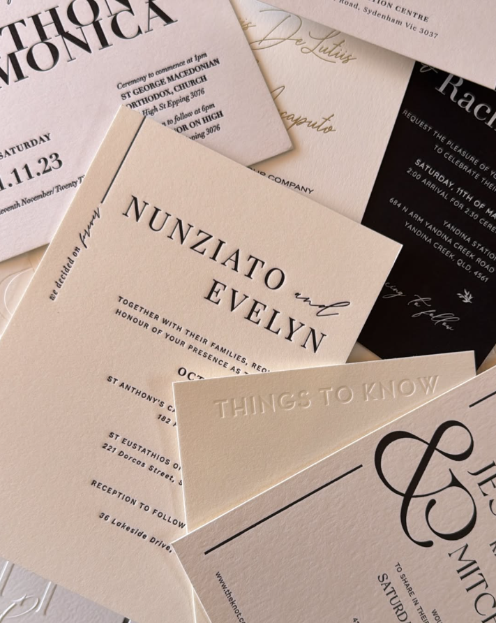 A collection of invitation cards and envelopes in various colors and designs.